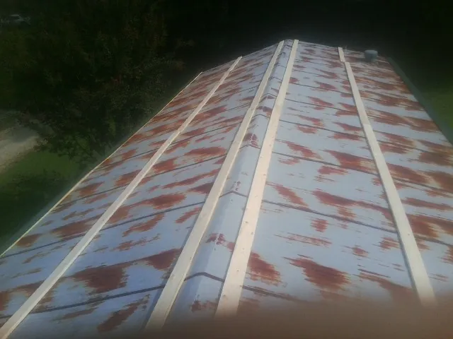 Rusted metal roof panels with new wood purlins before replacement — Storm Damage Roof Repair in Escalante by Roofing Brothers