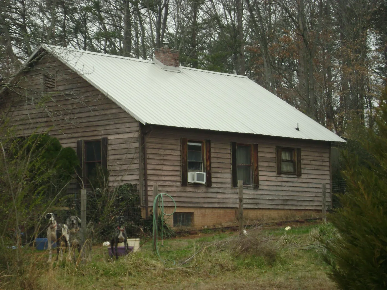 White metal roof on an old wood sided farmhouse, from a Metal Roof Installation job in Escalante